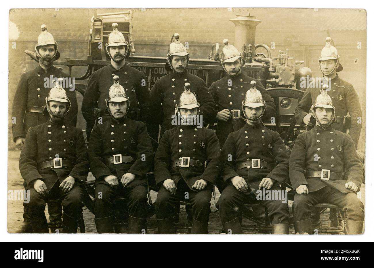 Original Edwardian era postcard of London County Council Metropolitan Fire Brigade (MFB)  crew and tender, Sunbury Street, Woolwich, posted 18 March 1905 from Woolwich, Southeast London, U.K. Vintage firefighters. Stock Photo