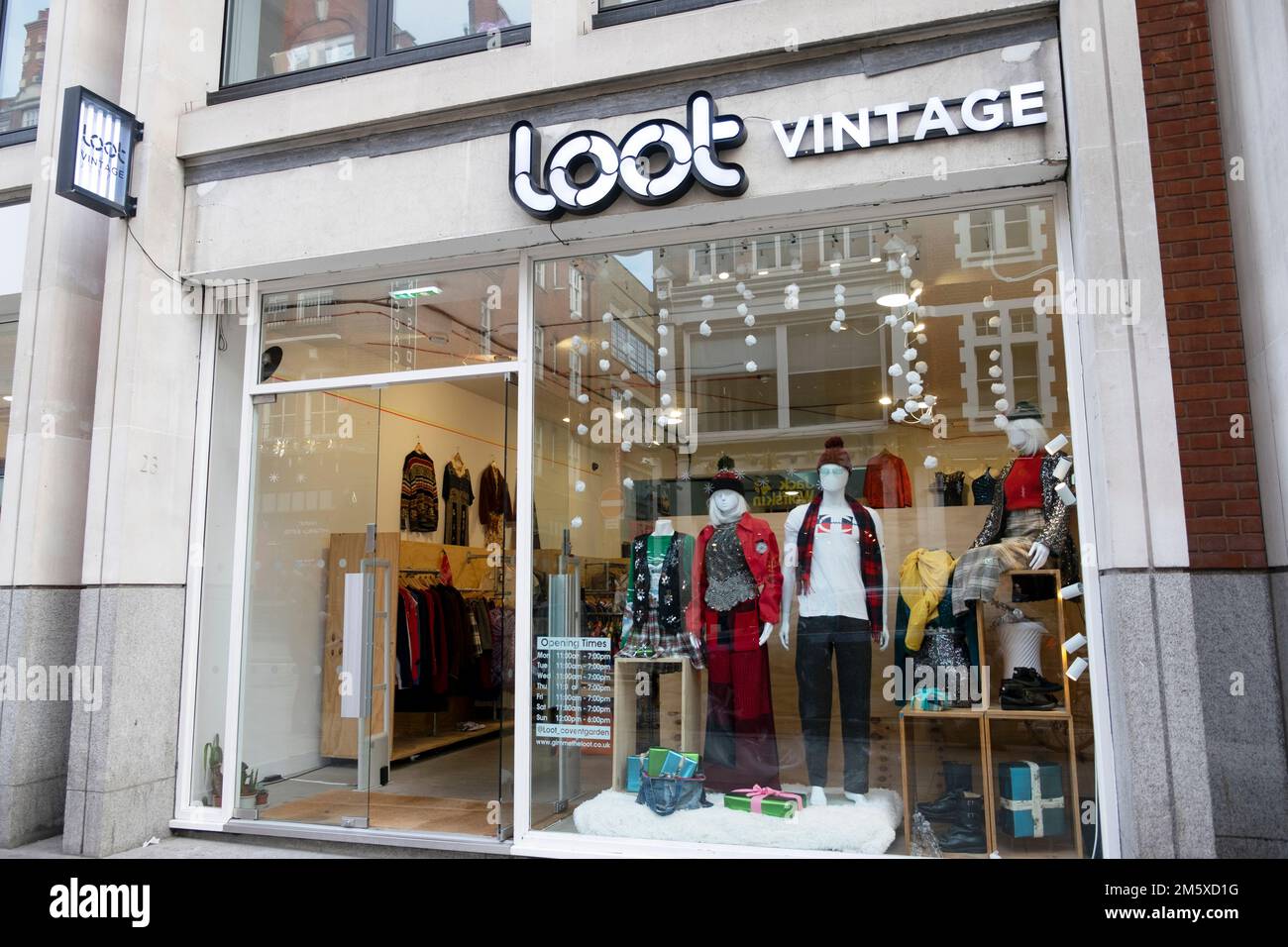 Exterior view of LOOT VINTAGE clothing store widow display in Long Acre Covent Garden at Christmas time in London WC2 UK England  KATHY DEWITT Stock Photo
