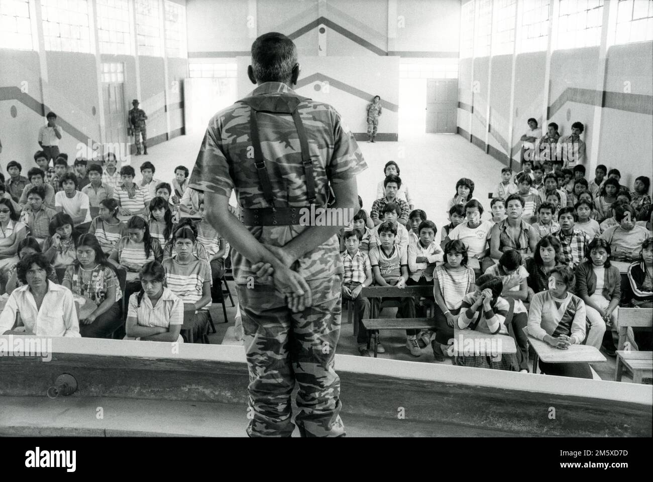 Guatemala, April 1986; The Guatemalan army  began a civil military programme in an attempt to improve their disasterous image with the rural population. Here here a radio announcer turned army captain, lectures school children at San Pedro Necta, Huehuetenango. Stock Photo