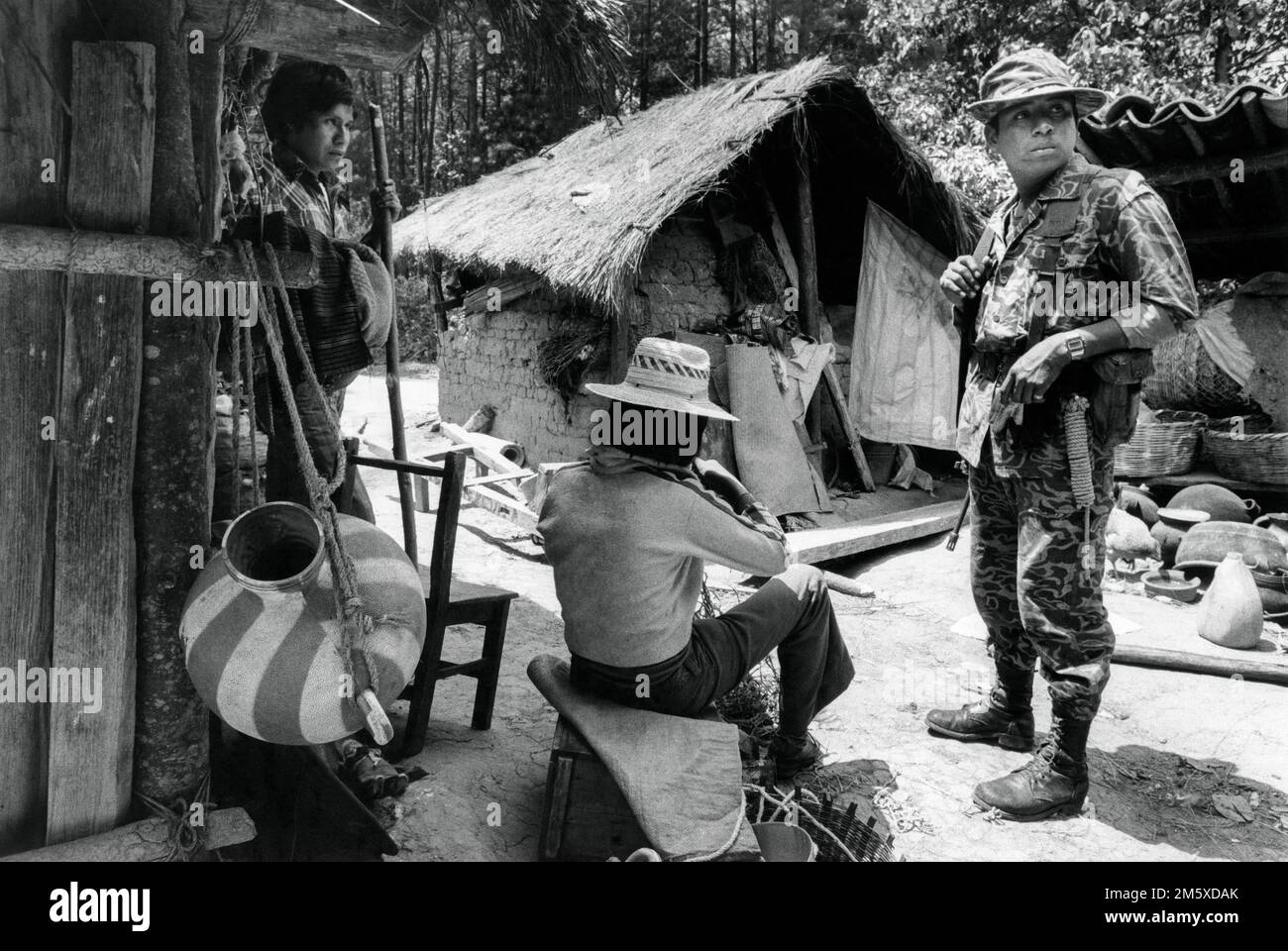 The army on patrol in an Indian village near Chichicastenango after a guerilla operation nearby. Guatemala, March 1982 Stock Photo