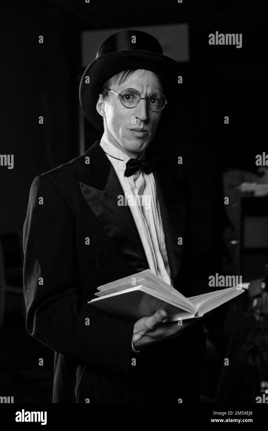 theater actor in a black top hat in the retro atmosphere of a merchant