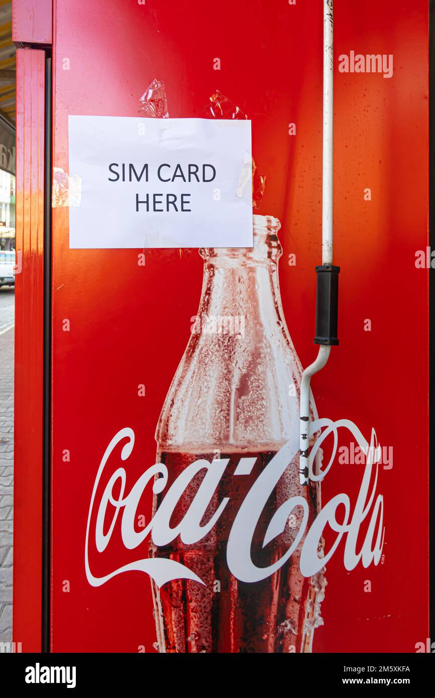 Coca-Cola street fridge with poster 'Sim Card here' Antalya, Turkey Stock Photo