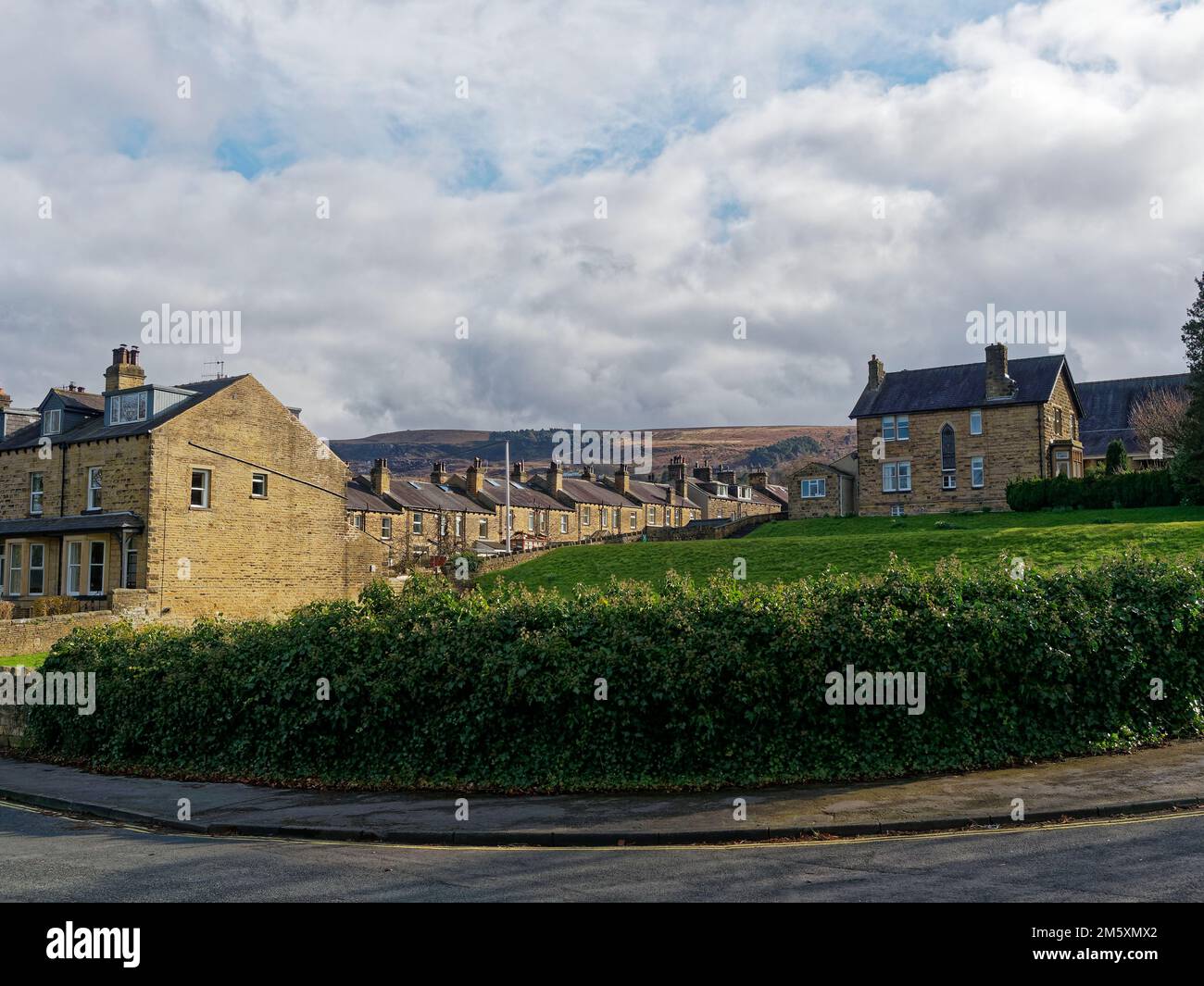 Some of the Stone houses and terraces near to Ilkley Park and Riverside Gardens with the hills of Ilkley Moor in the distance. Stock Photo
