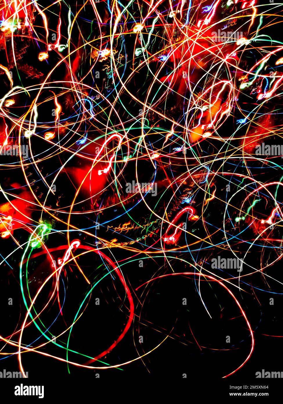 Light neon abstract lamps on black background blurry effect. Rainbow neon prism bokeh backdrop. Stock Photo