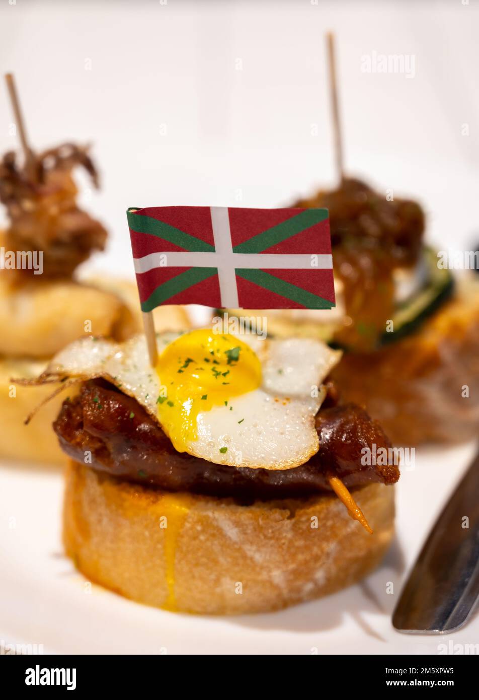 White board with typical snack and flag of Basque Country, pinchos or ...