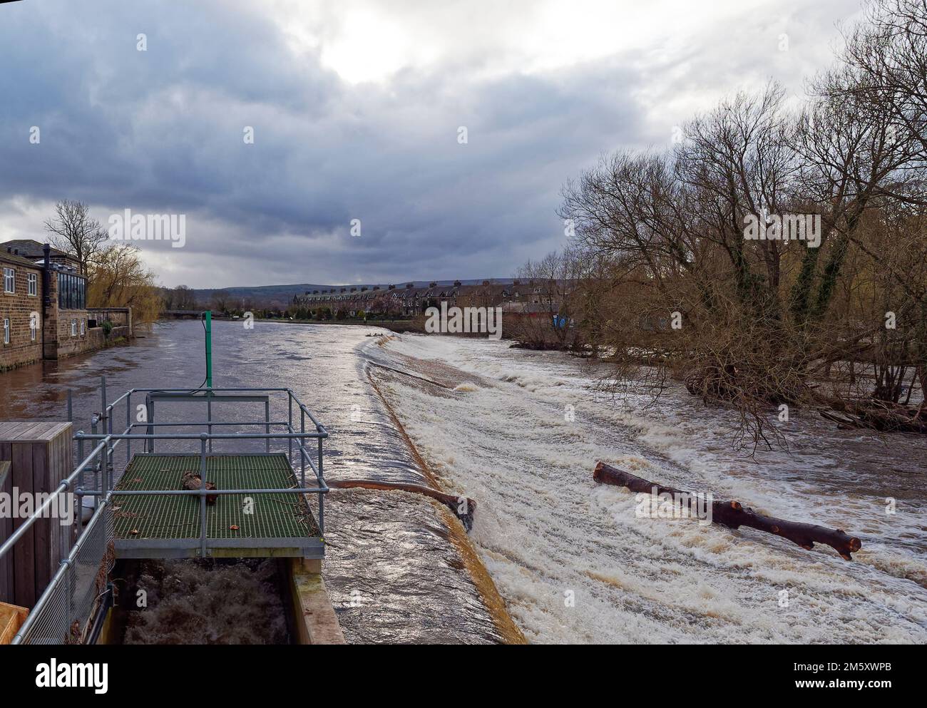 The weir at the River Wharfe in Otley with the river in spate after heavy rain throughout Yorkshire in late Winter. Stock Photo