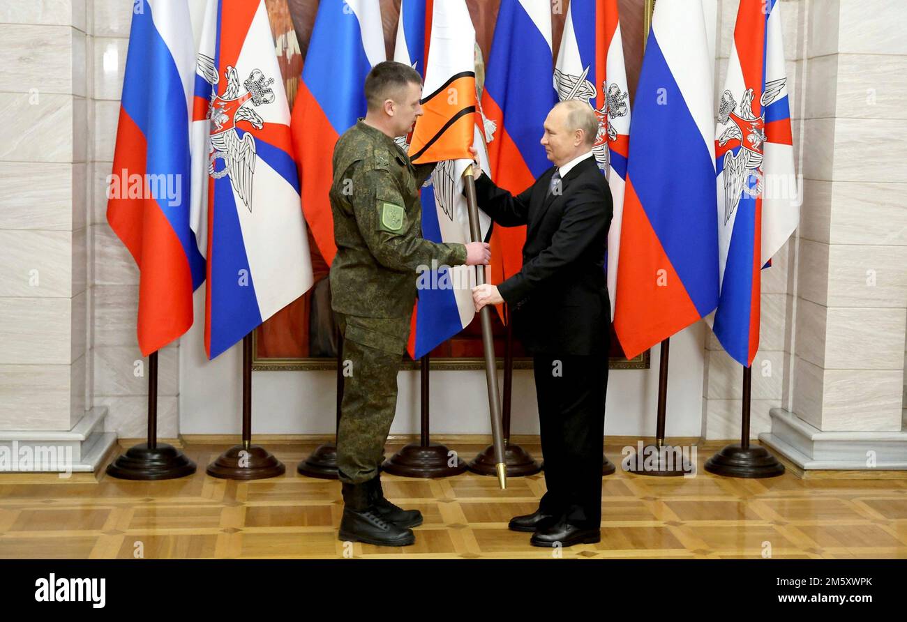 Rostov-on-Don, Russia. 31st Dec, 2022. Russian President Vladimir Putin presents soldiers with the 1st Donetsk Army Corps, 2nd Lugansk-Severodonetsk Army Corps, Donetsk Higher Combined Arms Command School with banners during a ceremony at the Southern Military District headquarters, December 31, 2022 in Rostov-on-Don, Russia. Putin presented awards and delivered his New Year address during the visit. Credit: Mikhail Klimentyev/Kremlin Pool/Alamy Live News Stock Photo