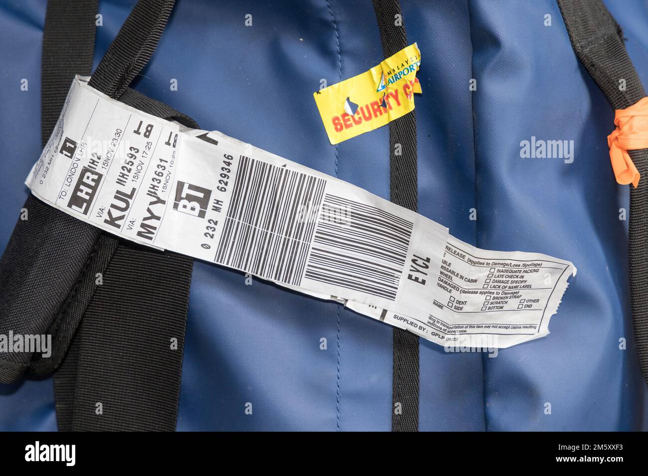 Example of luggage tag and security sticker on checked baggage for flying Stock Photo