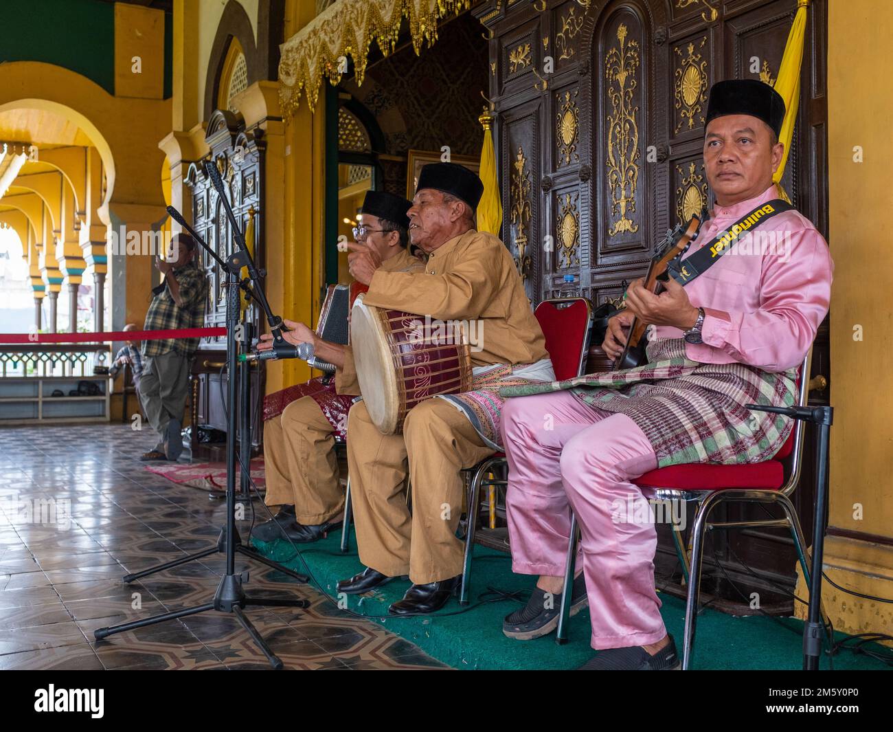 Medan, Indonesia - July 21, 2022: Three musician performing traditional music. Stock Photo