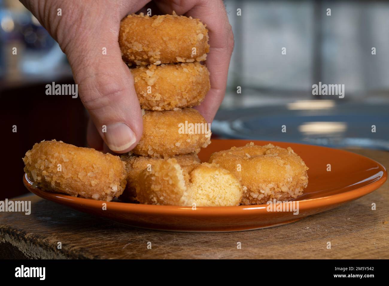 Stack of doughnuts with hand taking 3 Stock Photo
