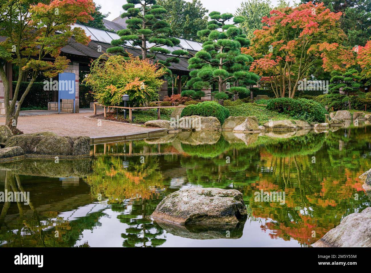 Amazung view with pond and reflections and gazebo in Japanese garden of