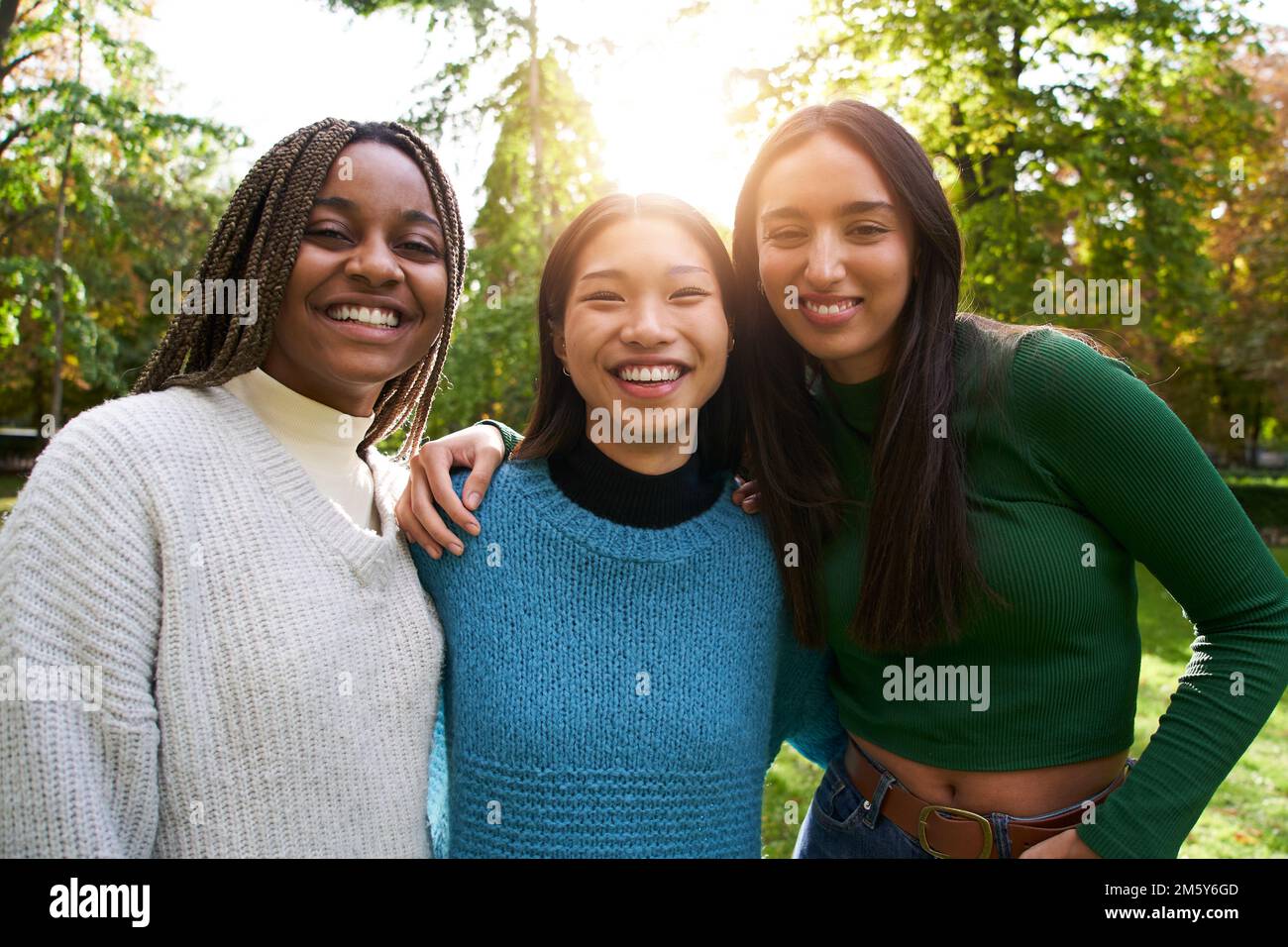 Portrait of three girls outside looking at the camera. Friendship in multi-ethnic groups of people Stock Photo