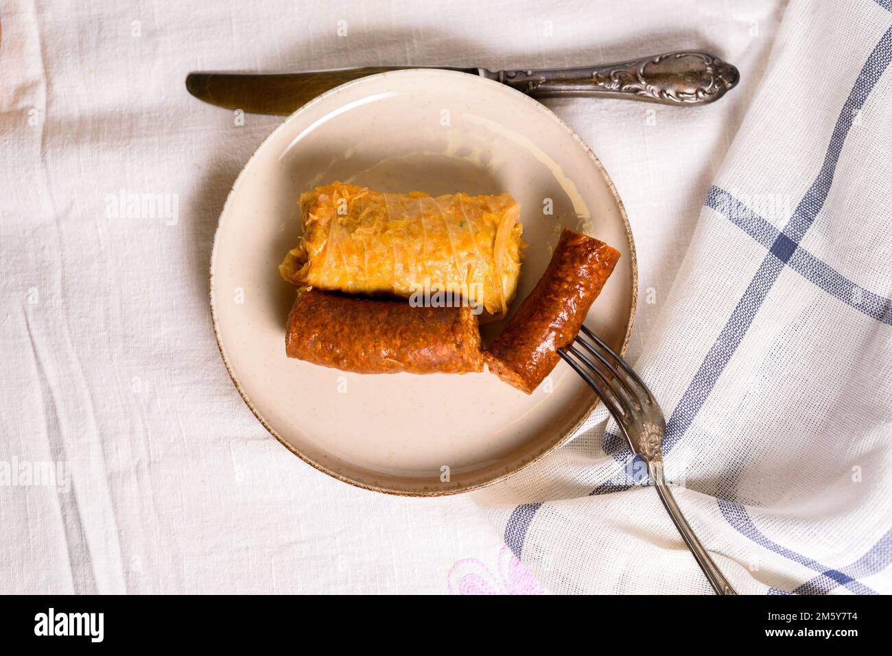 Stuffed cabbage rolls with meat and sausages on a plate Stock Photo Alamy