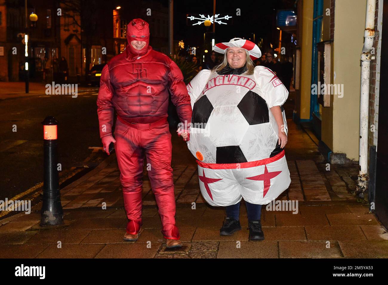 Bridport, Dorset, UK.  31st December 2022.  Revellers wearing fancy dress in Bucky Doo Square at Bridport in Dorset at midnight for the towns New Year celebrations.  Picture Credit: Graham Hunt/Alamy Live News Stock Photo