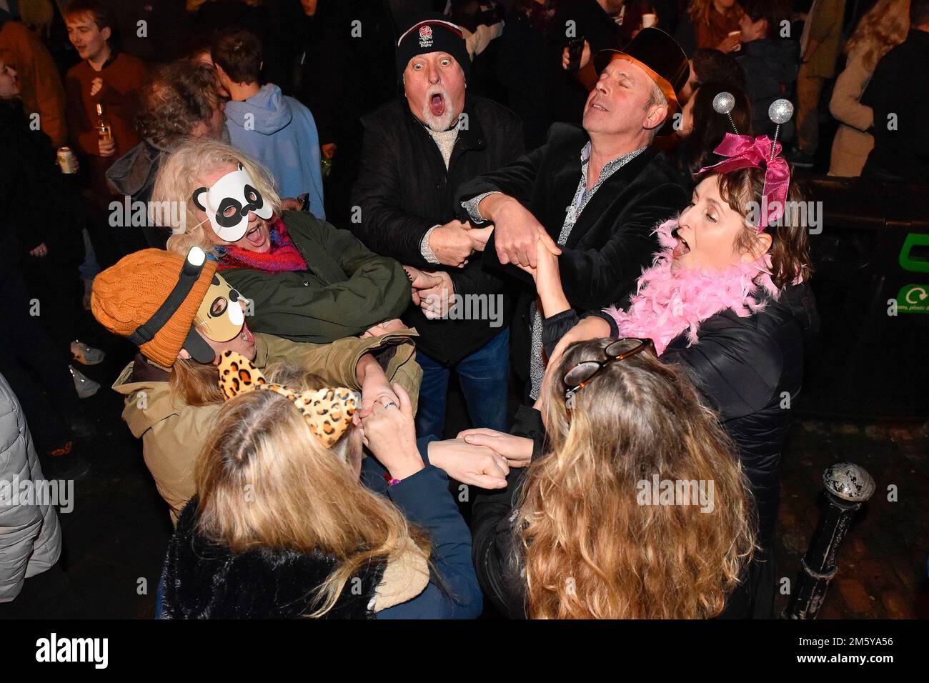 Bridport, Dorset, UK.  31st December 2022.  Revellers in Bucky Doo Square at Bridport in Dorset at midnight for the towns New Year celebrations.  Picture Credit: Graham Hunt/Alamy Live News Stock Photo