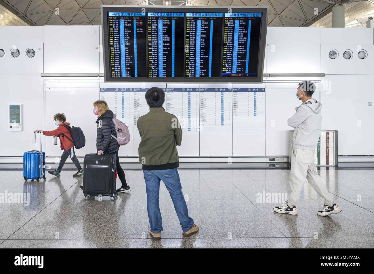 hong-kong-china-29th-dec-2022-passengers-look-at-a-screen-where