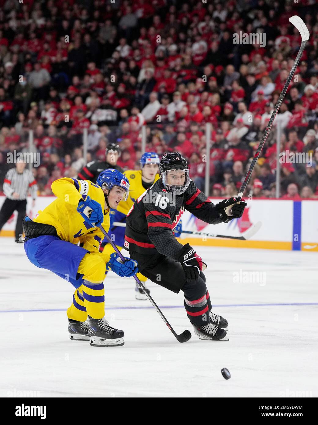 Canadas Connor Bedard, right, and Swedens Calle Odelius, left, vie for the puck during the second period of an IIHF world junior hockey championships game Saturday, Dec