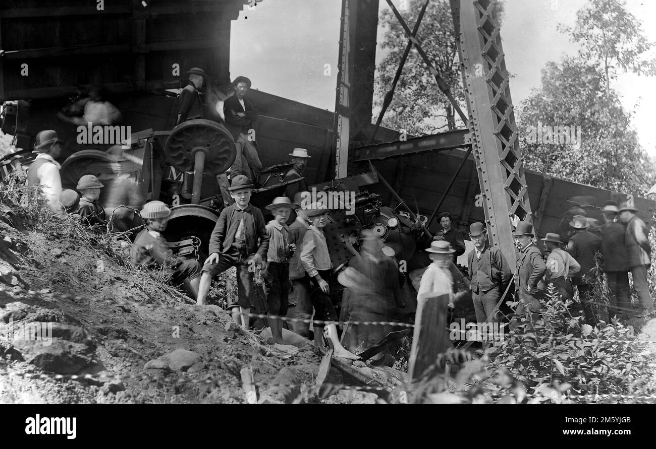 A crowd investigates a train derailment in New York State, ca. 1890. Stock Photo