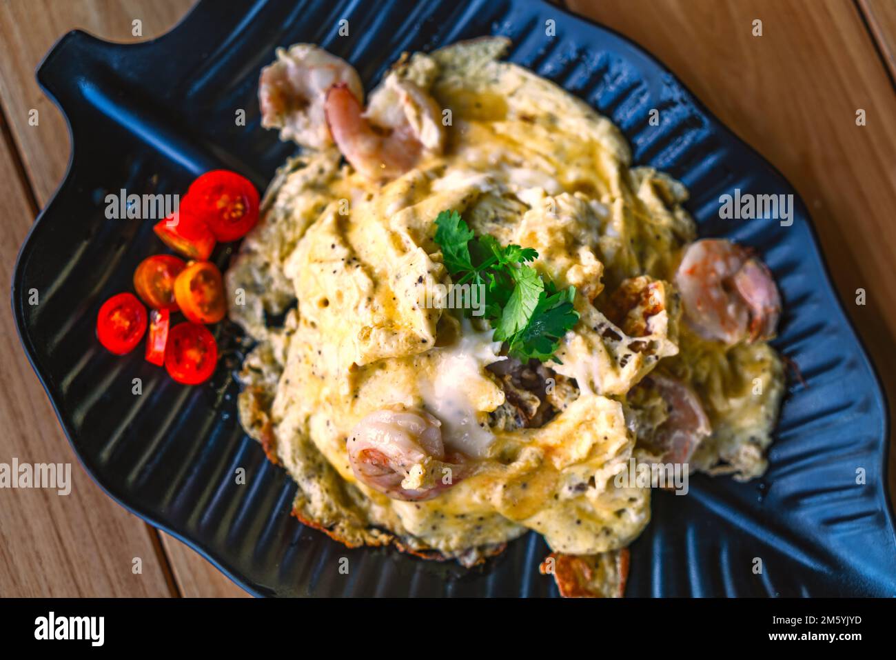 Thai food style of Scrambled eggs with shrimp over rice on a beautiful