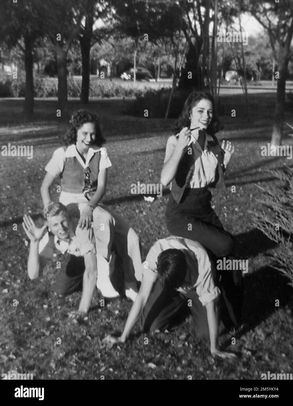 High school age couples have fun together outside, ca. 1948. Stock Photo