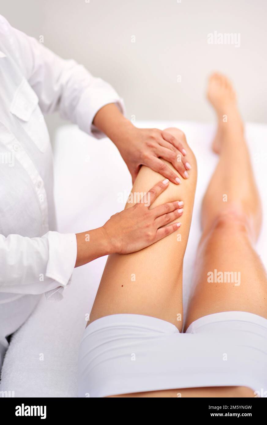 Working out all that tension. a woman enjyoing a massage at the day spa. Stock Photo