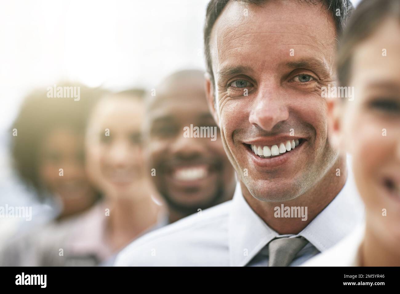 He stands out in a crowd. Cropped portrait of a group of coworkers