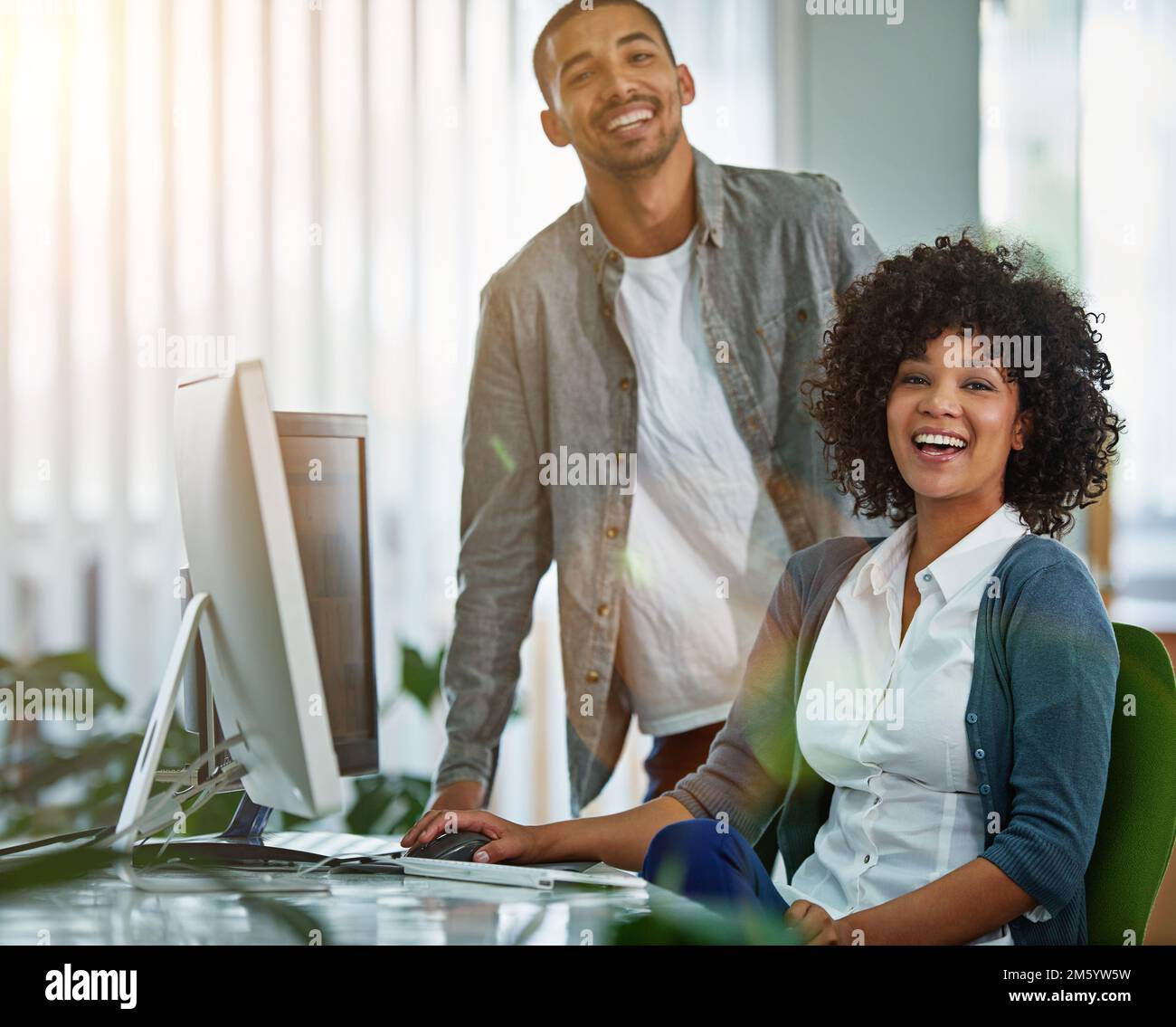 Were at the top of our game. Portrait of designers working together at a workstation in an office. Stock Photo