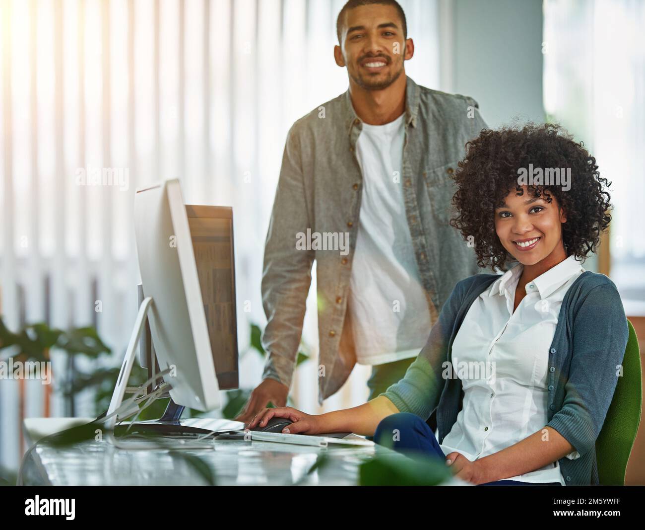 Were young innovators. Portrait of designers working together at a workstation in an office. Stock Photo