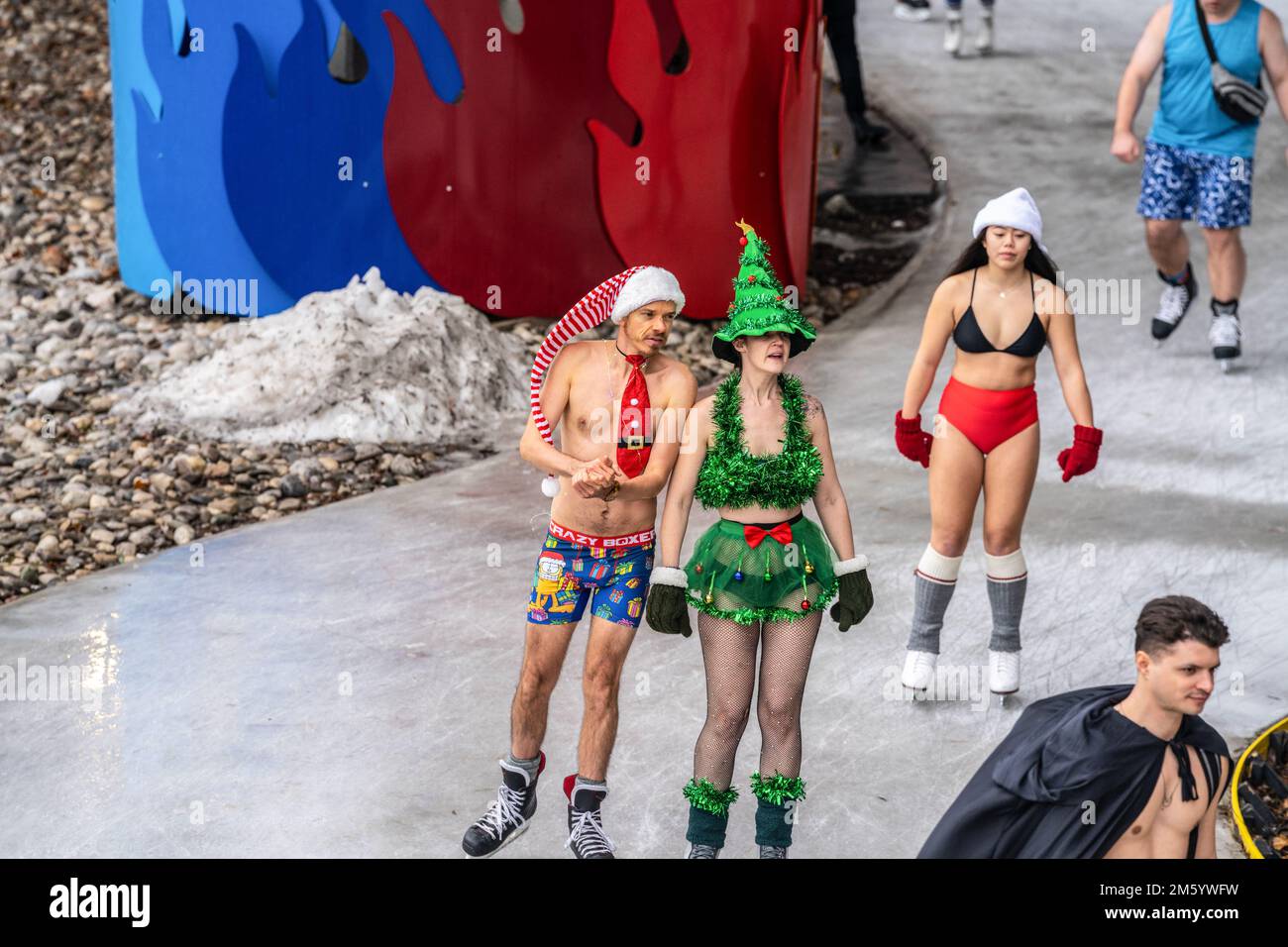 Ice skaters dressed in Christmas costumes skate along a frozen trail. The  Beltway Polar Bear Skate is a clothing drive organized by The Beltway  Conservancy to collect warm winter clothes and celebrate