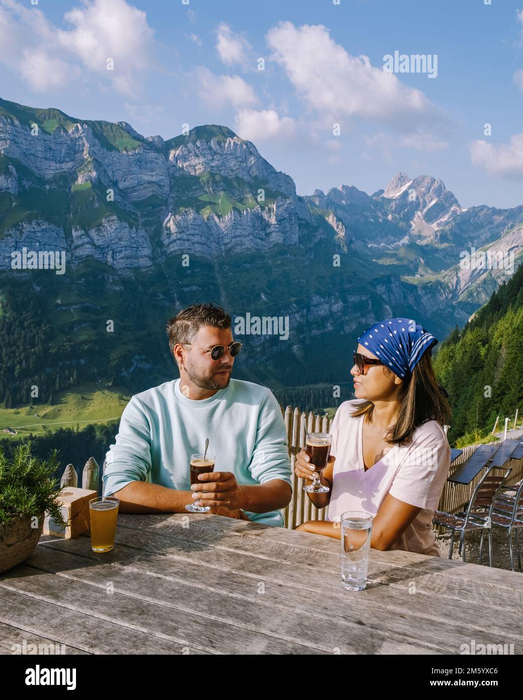 Couple drinking coffee at a restaurant in the Swiss alps, mountain