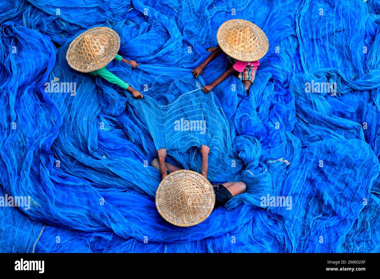 Fishermen seen making blue fishing nets in the Canning area of Sundarbans. Canning is located
