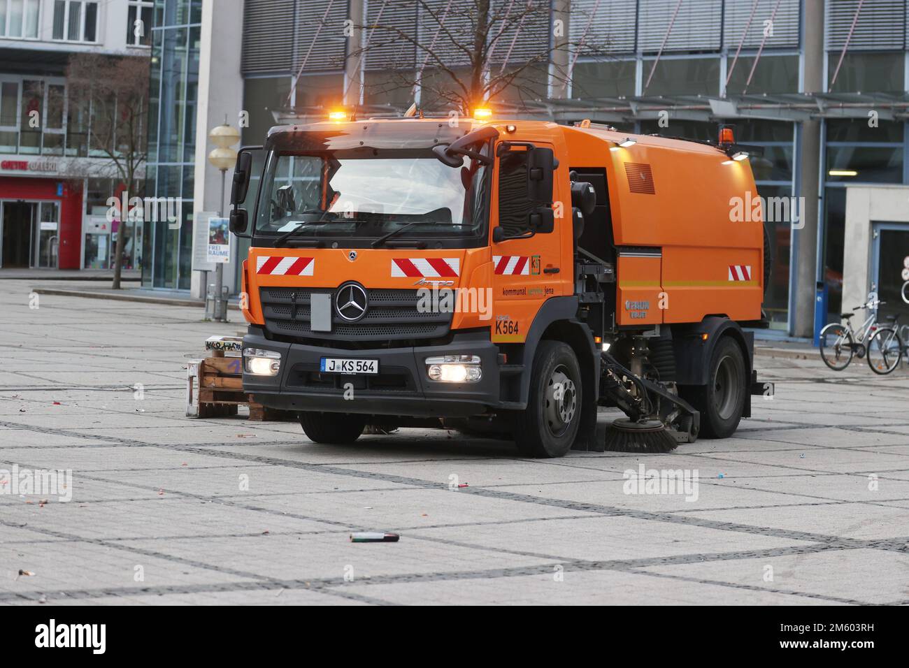 Jena, Germany. 01st Jan, 2023. A sweeper of the municipal municipal service removes remains of fireworks on Ernst Abbe Platz in the center. According to the state police department, there was a high volume of operations on New Year's Eve. Credit: Bodo Schackow/dpa/Alamy Live News Stock Photo
