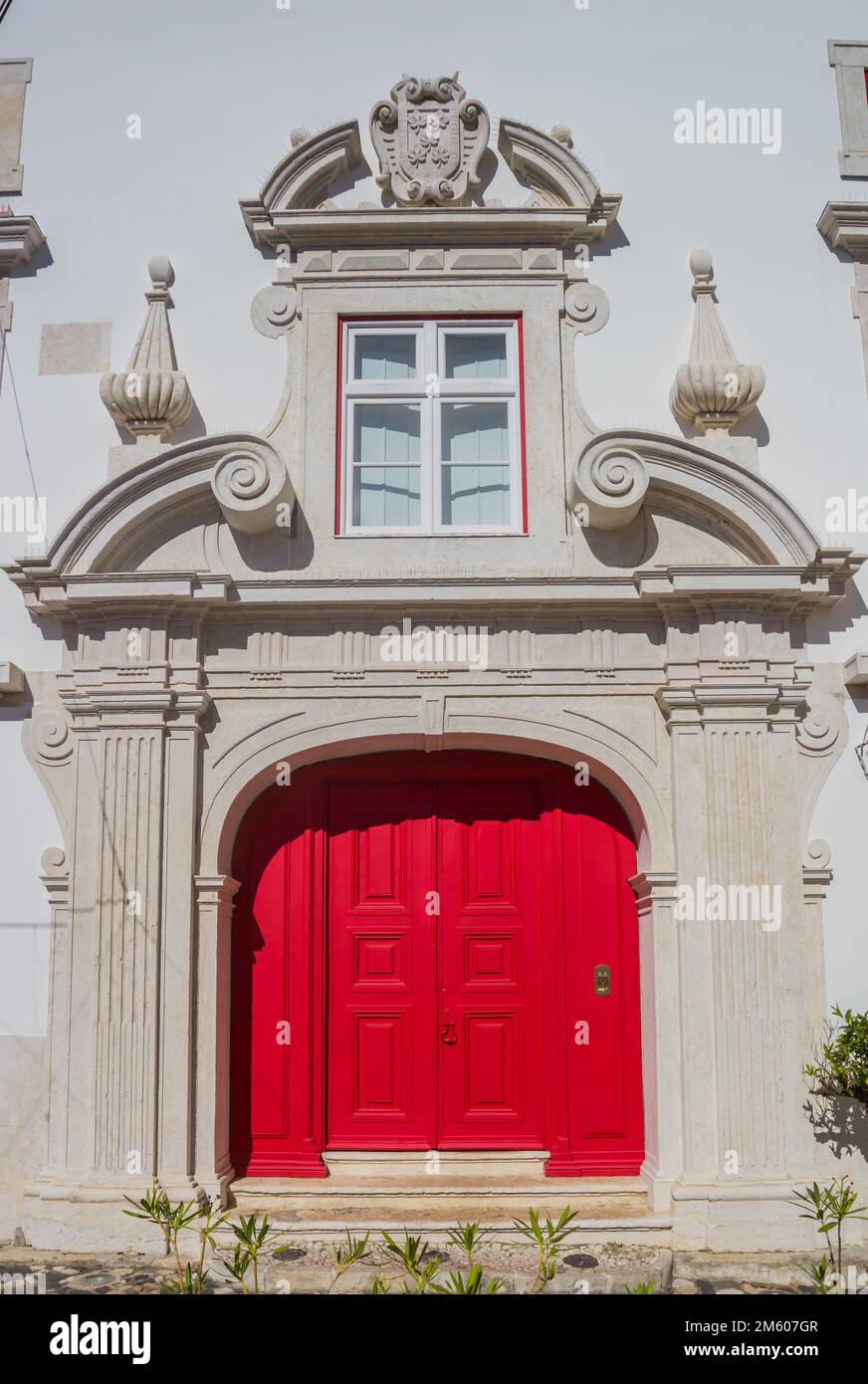 Red door in a white church in Lisbon, Portugal Stock Photo