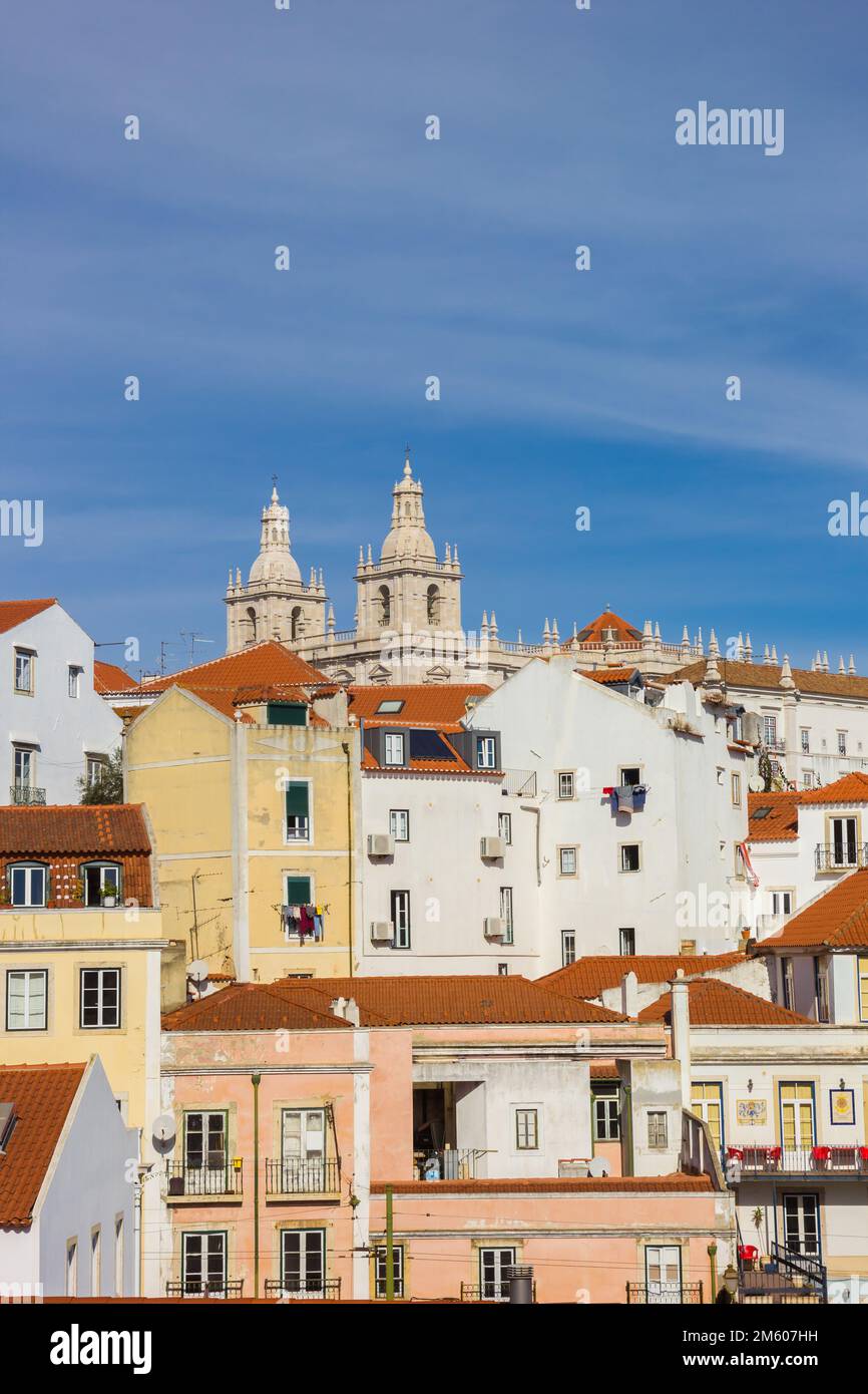 Towers of the Sao Vicente church and traditional houses in Lisbon, Portugal Stock Photo