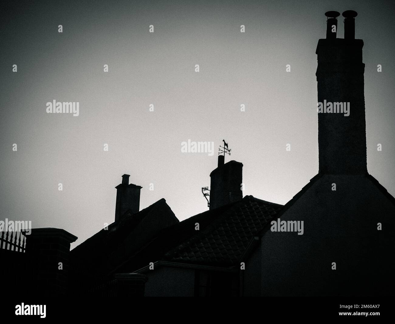 Monochrome silhouetted rooflines of houses in Westbury Leigh, Wiltshire, England. Stock Photo