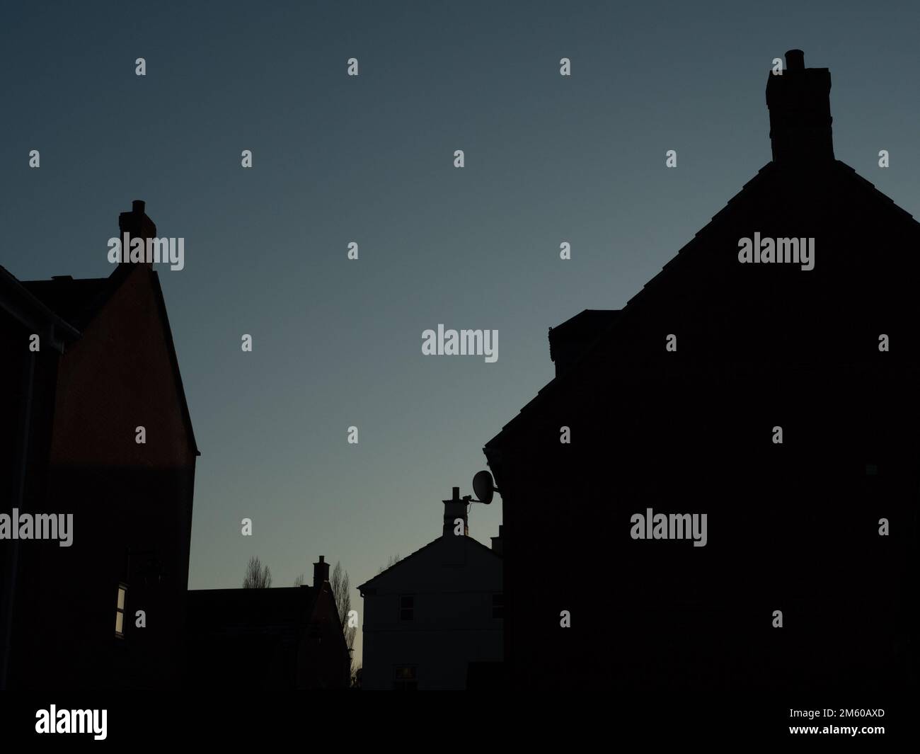 Silhouetted rooflines of houses in Westbury Leigh, Wiltshire, England