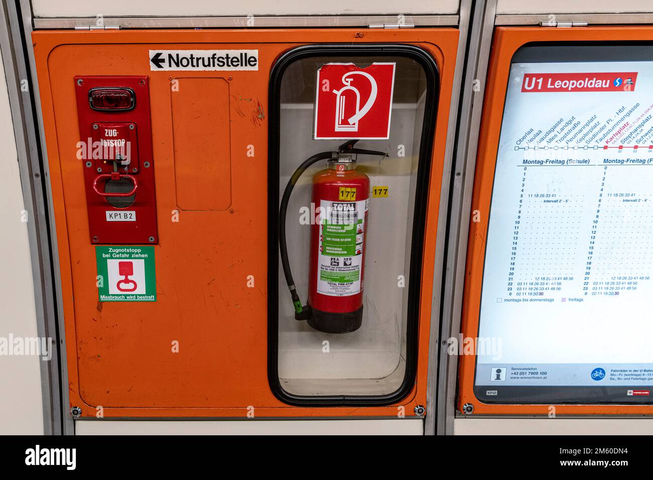 Fire extinguisher behind glass at Vienna undergraound station Stock