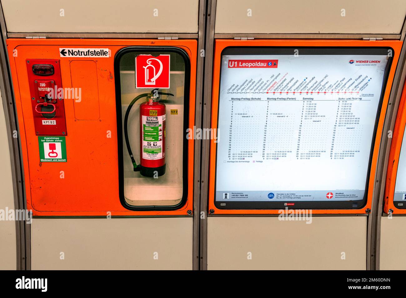 Fire extinguisher behind glass at Vienna undergraound station Stock
