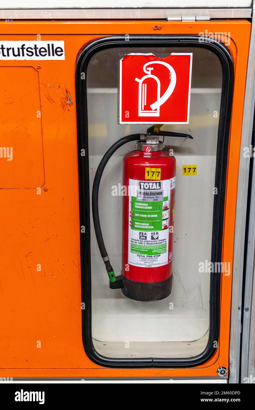 Fire extinguisher behind glass at Vienna undergraound station Stock