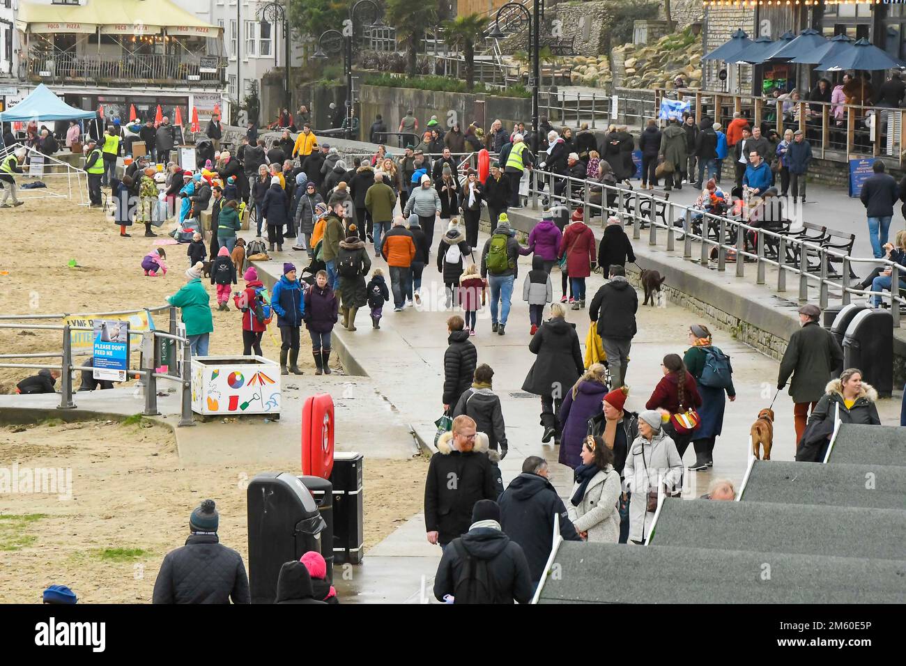 Lyme Regis, Dorset, UK.  1st January 2023.  UK Weather.  Families and visitors pack the seafront at Lyme Regis in Dorset on a damp and overcast New Years Day.  Picture Credit: Graham Hunt/Alamy Live News Stock Photo