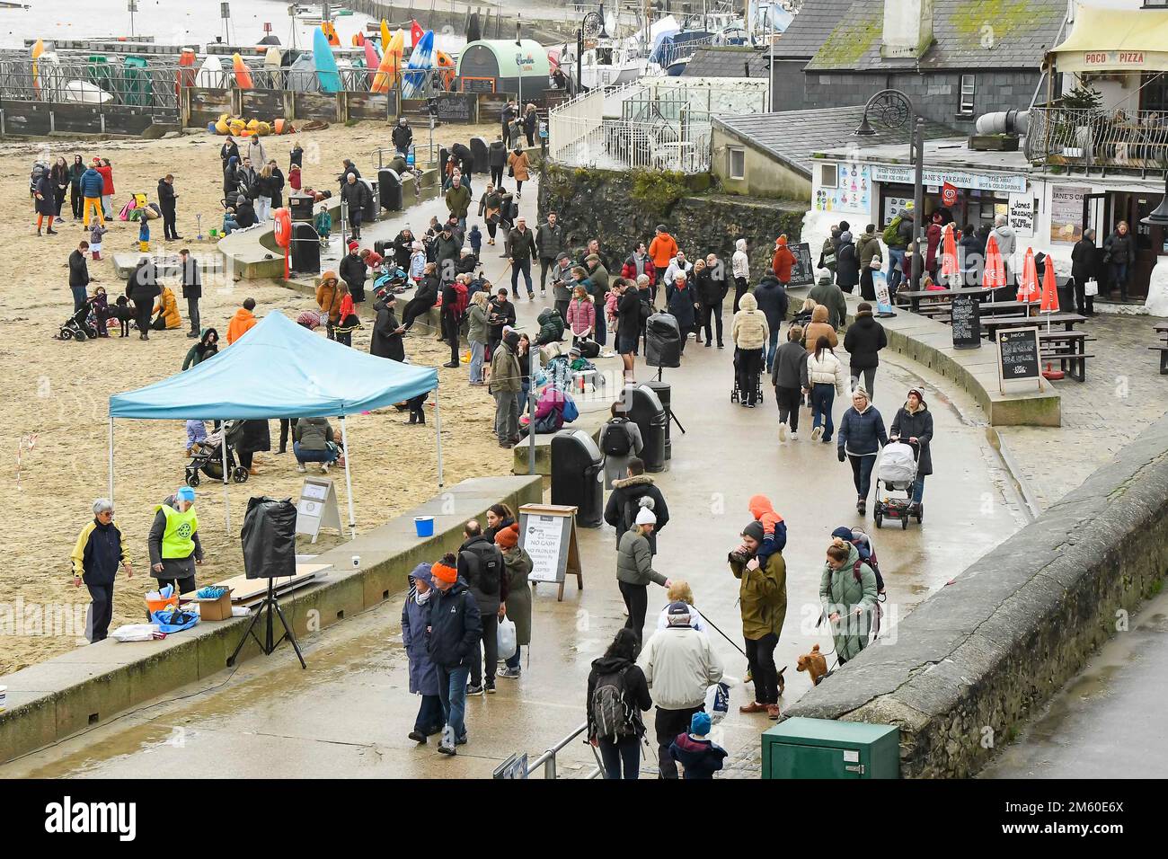 Lyme Regis, Dorset, UK.  1st January 2023.  UK Weather.  Families and visitors pack the seafront at Lyme Regis in Dorset on a damp and overcast New Years Day.  Picture Credit: Graham Hunt/Alamy Live News Stock Photo