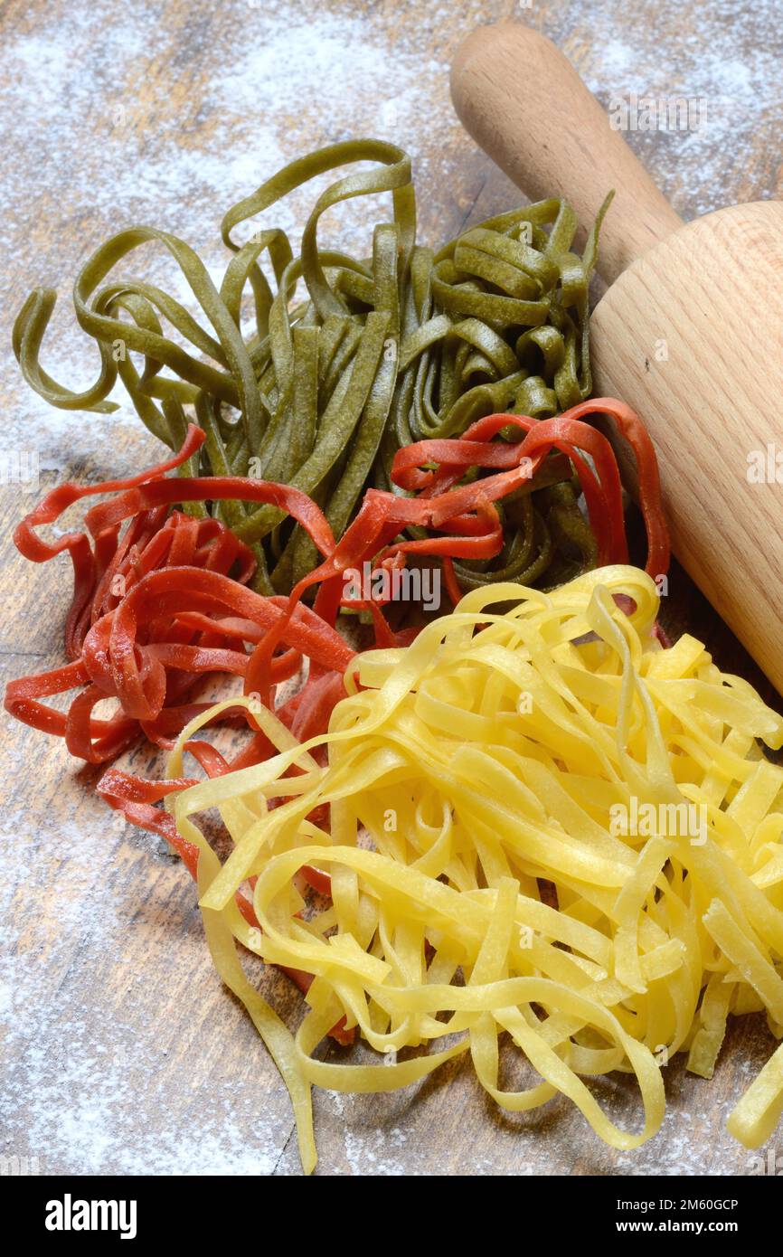Tagliatelle tricolore, Italian pasta with dough roll Stock Photo - Alamy