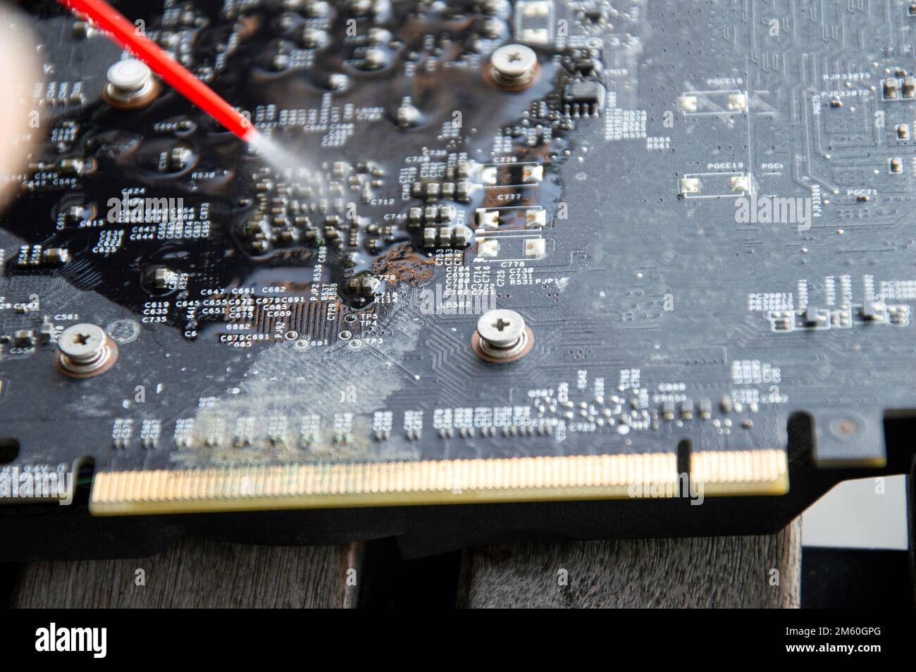 Technician view using spray to clean graphics card Stock Photo Alamy