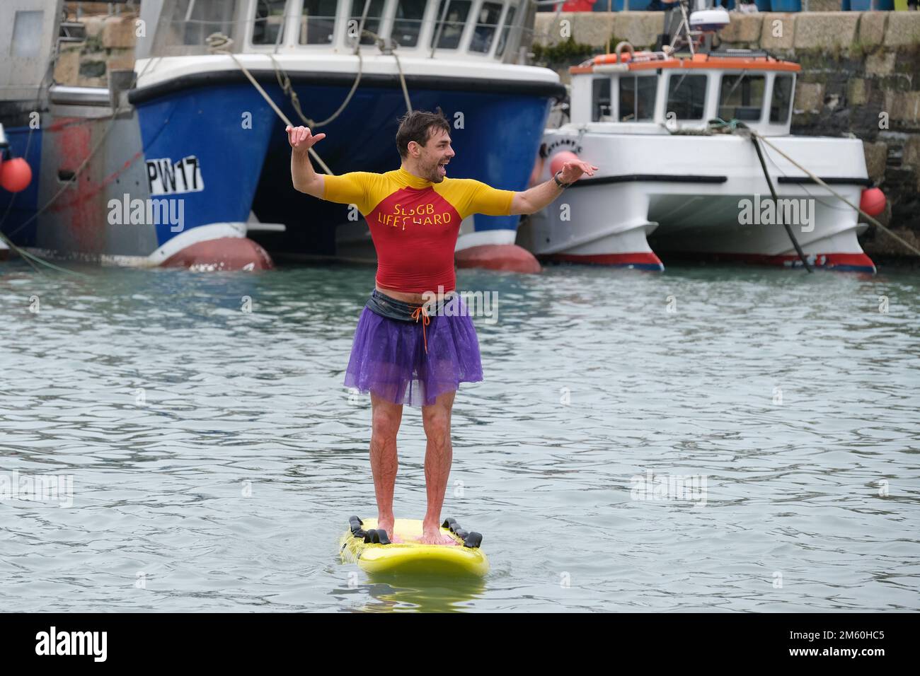 Newquay Harbour, Cornwall, UK. 1 January 2023. UK Weather. Hundreds of people, many in fancy dress, ran into the icy waters at Newquay today, and in the process raised cash for a local cancer charity. Credit Simon Maycock / Alamy LIve News. Stock Photo