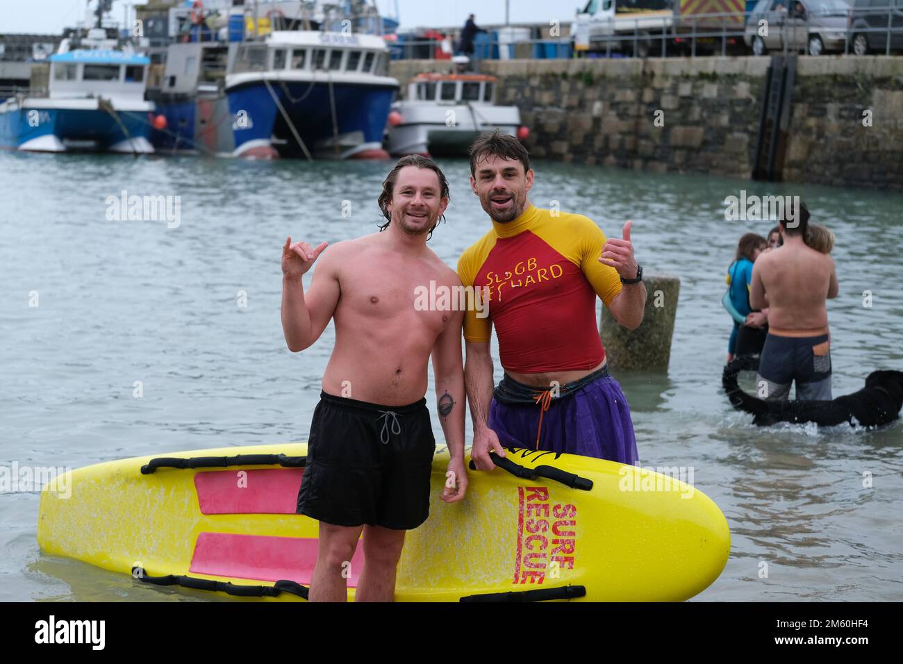 Newquay Harbour, Cornwall, UK. 1 January 2023. UK Weather. Hundreds of people, many in fancy dress, ran into the icy waters at Newquay today, and in the process raised cash for a local cancer charity. Credit Simon Maycock / Alamy LIve News. Stock Photo