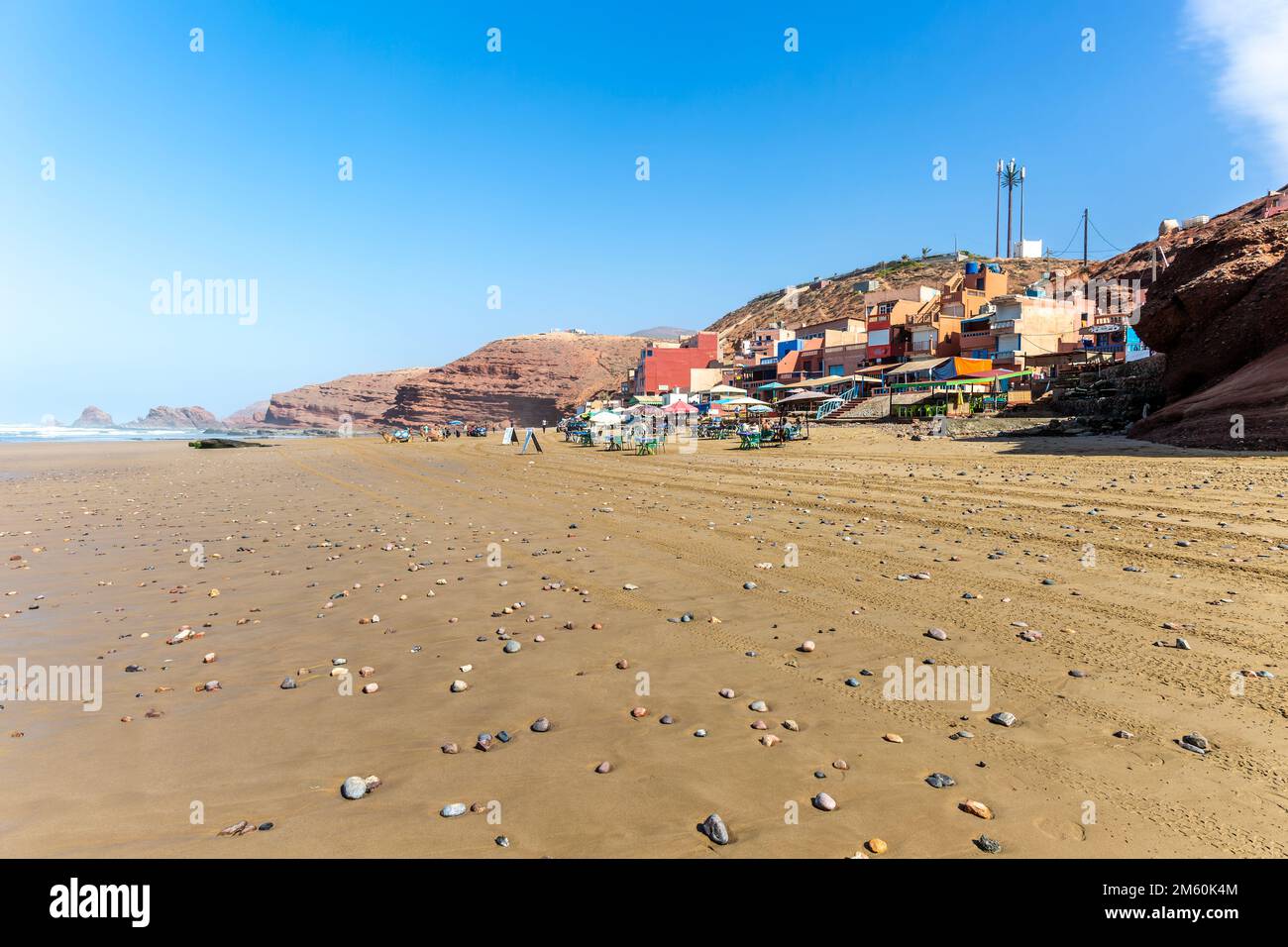 Sandy beach and buildings, Legzira, southern Morocco, north Africa Stock Photo