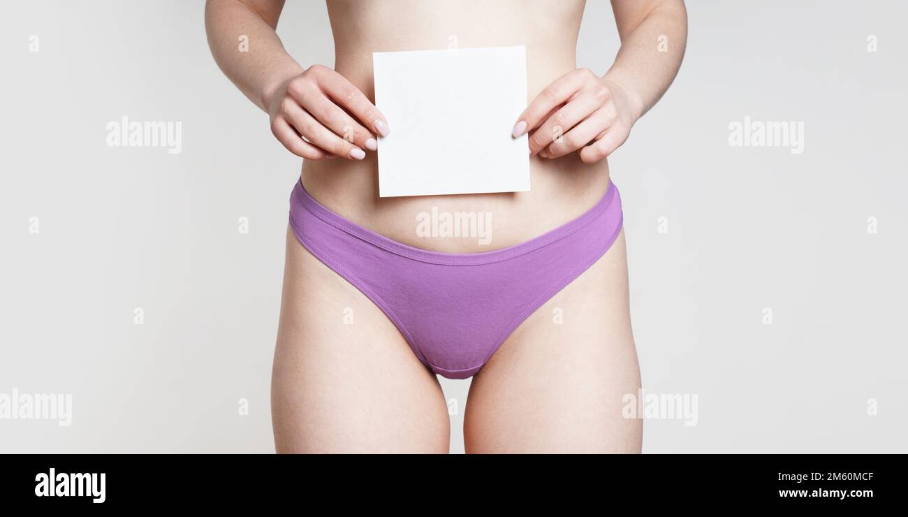 woman in panties holding blank sign with copy space as women's health or female sexuality concept Stock Photo