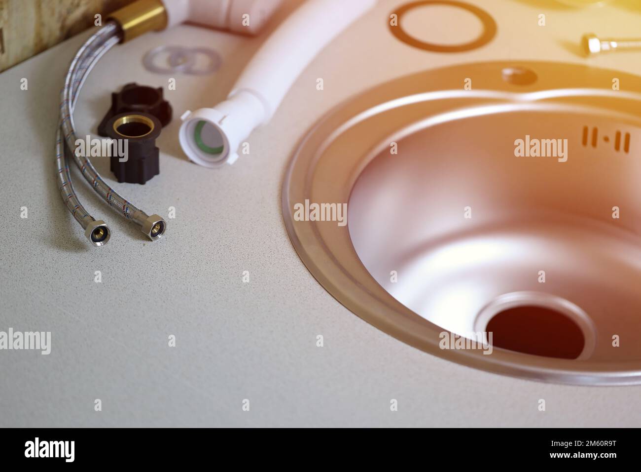 Plumbers tools and water tap ready for installation near sink on