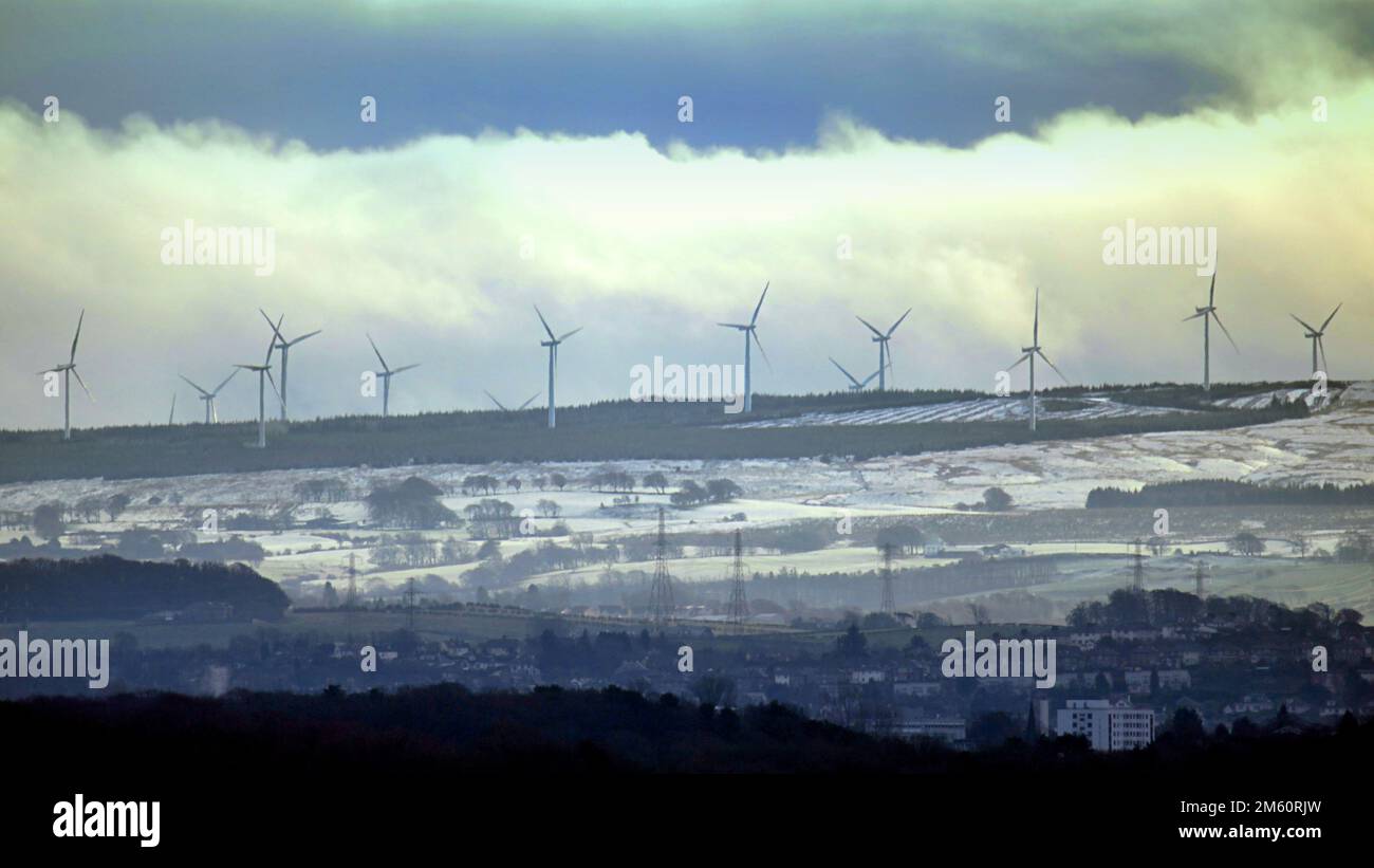 Glasgow, Scotland, UK 1stJanuary, 2023. UK Weather: new years day  Snow on the hills south of the city amongst the wind turbines surrounding it. Credit Gerard Ferry/Alamy Live News Stock Photo