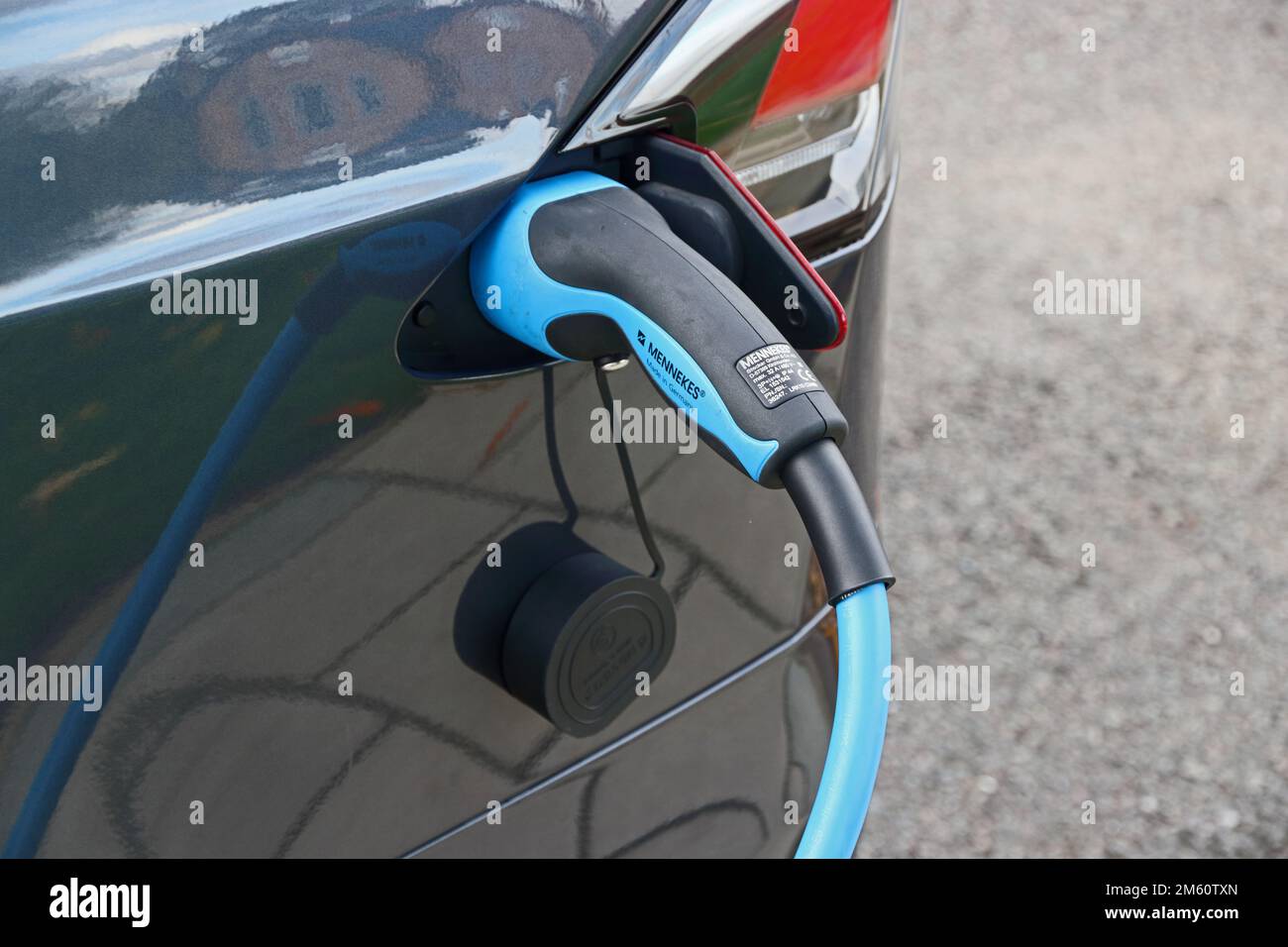 Charging cable connected to Tesla electric car Stock Photo